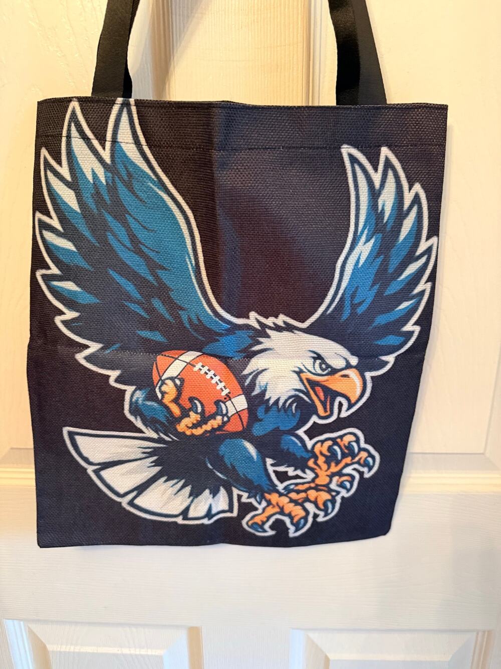 Philadelphia Eagles black tough fabric tote bag featuring a graphic illustration